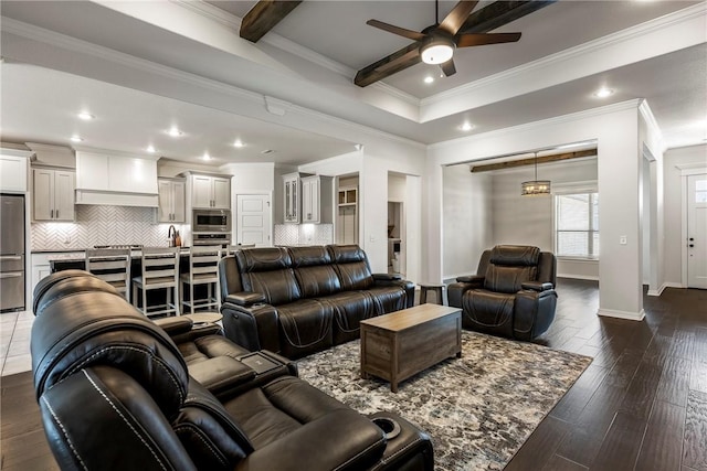 living room with recessed lighting, dark wood-type flooring, a ceiling fan, baseboards, and beamed ceiling