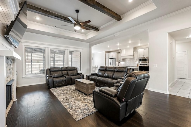 living area with a fireplace, wood finished floors, beam ceiling, and crown molding