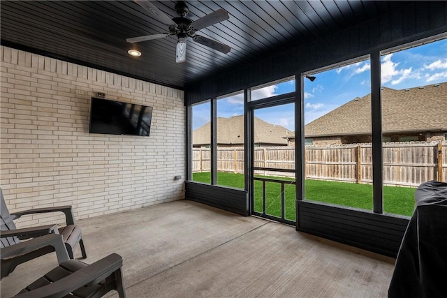 sunroom / solarium with wooden ceiling and a ceiling fan