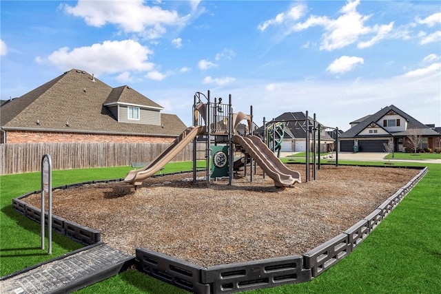 communal playground with a lawn and fence