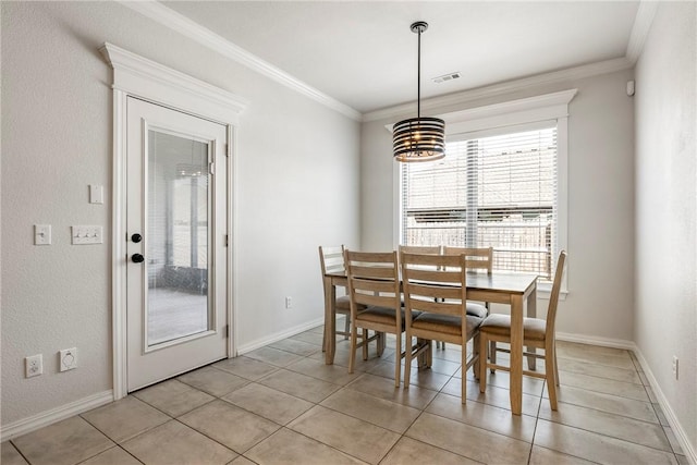 dining space featuring baseboards, visible vents, and crown molding