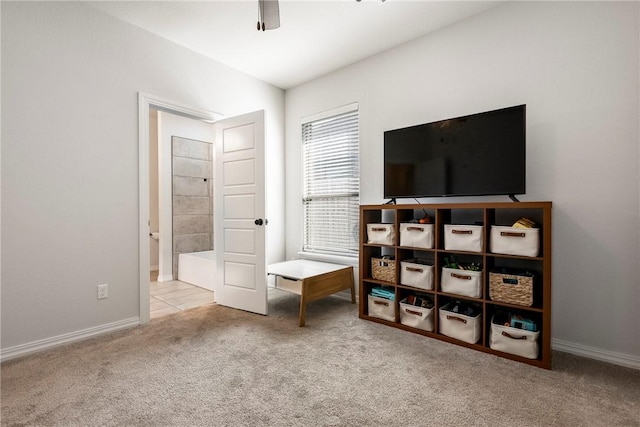 carpeted bedroom with a ceiling fan and baseboards