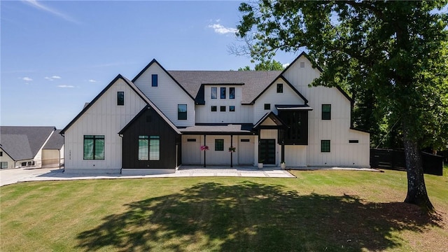 modern farmhouse featuring board and batten siding and a front yard