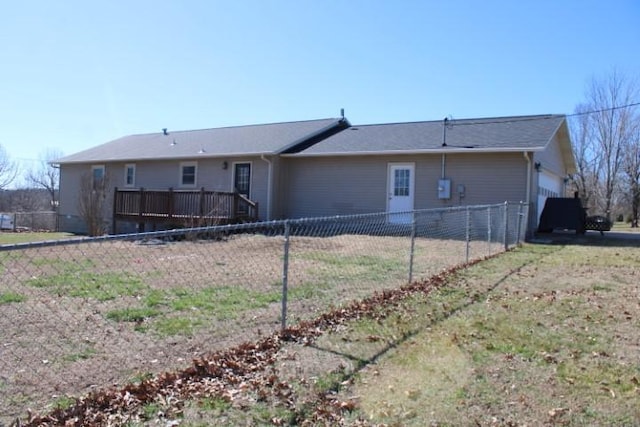 rear view of property featuring a fenced backyard