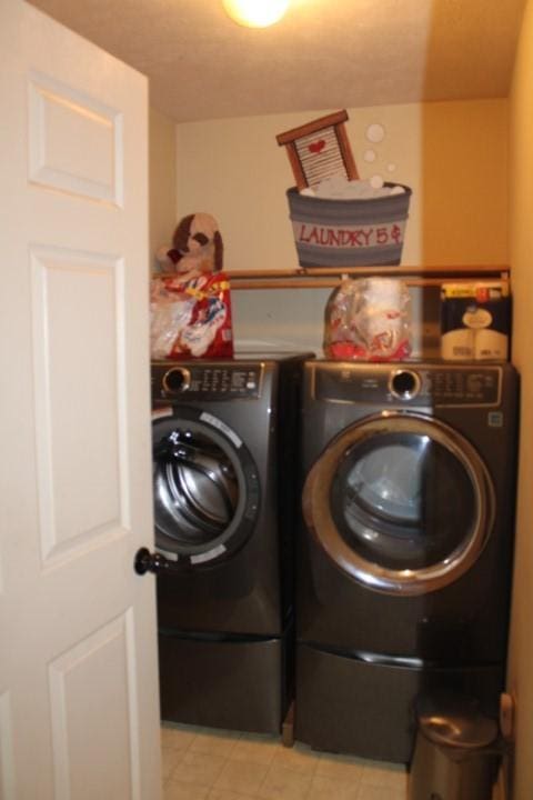 clothes washing area with laundry area and separate washer and dryer