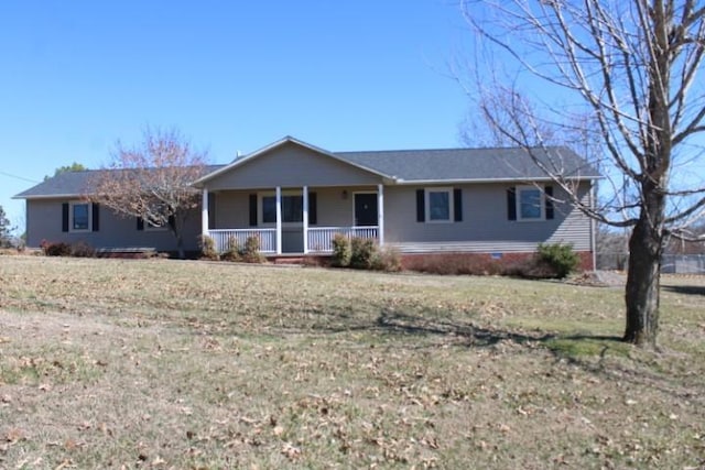 single story home featuring covered porch and a front lawn