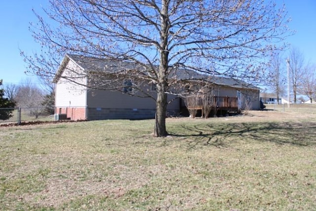 view of side of home featuring a yard and fence