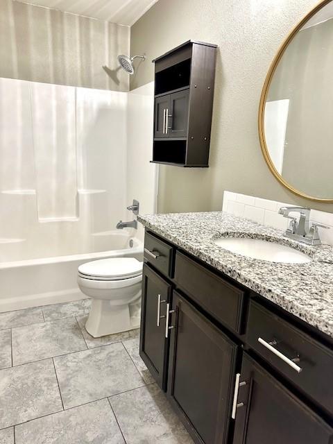 full bathroom featuring toilet, tub / shower combination, and vanity