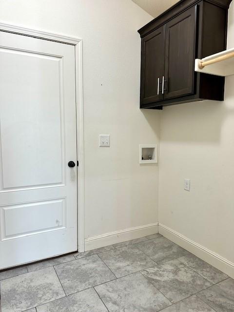 laundry area featuring washer hookup, cabinet space, and baseboards