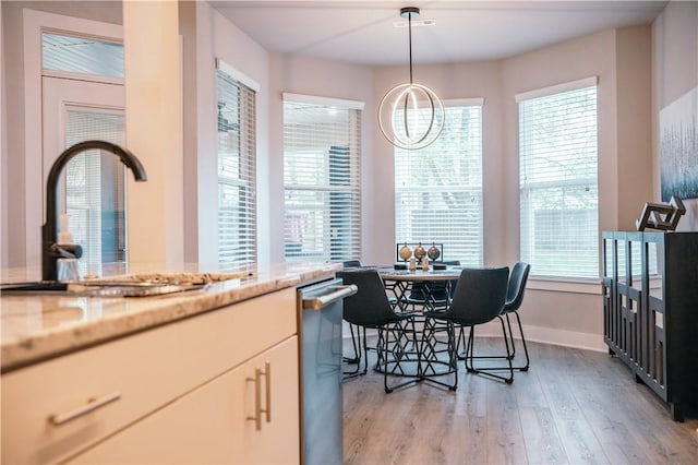 dining space featuring baseboards and light wood-style floors