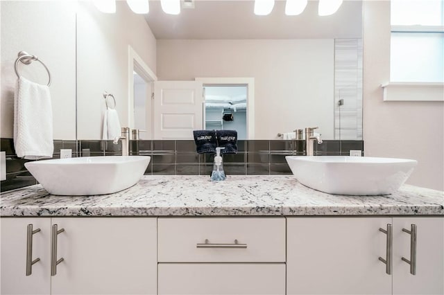 bathroom featuring a sink and double vanity