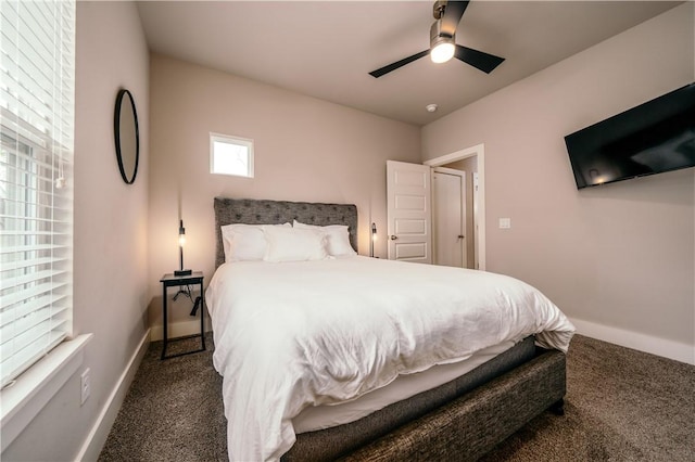 carpeted bedroom with a ceiling fan and baseboards