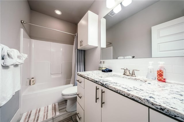 full bathroom with shower / tub combo, visible vents, toilet, vanity, and backsplash