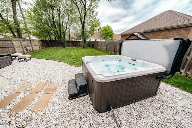 view of patio with a hot tub and a fenced backyard