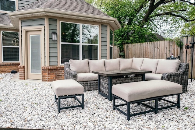 view of patio featuring fence and an outdoor living space