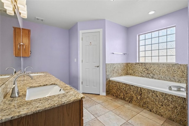 full bathroom featuring tile patterned floors, visible vents, a sink, and a bath