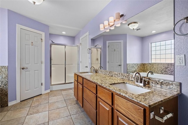 bathroom with tile patterned flooring, a sink, and a shower stall