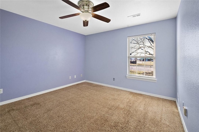 unfurnished room featuring a ceiling fan, baseboards, visible vents, and carpet flooring