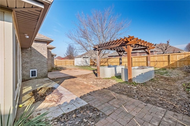 view of patio featuring a storage shed, a fenced backyard, a pergola, and an outdoor structure