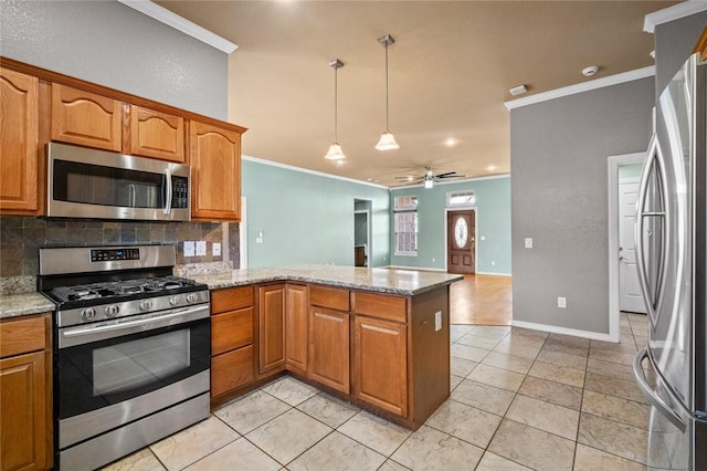 kitchen with appliances with stainless steel finishes, ornamental molding, a peninsula, and decorative backsplash