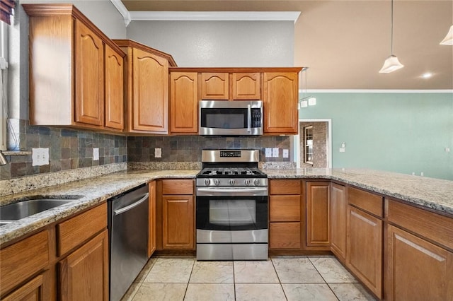 kitchen featuring stainless steel appliances, brown cabinets, a sink, and crown molding