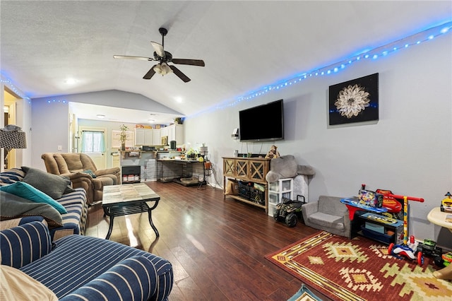 living room with vaulted ceiling, hardwood / wood-style flooring, and a ceiling fan