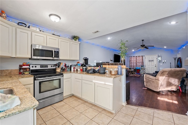 kitchen featuring light tile patterned flooring, stainless steel appliances, a peninsula, visible vents, and open floor plan