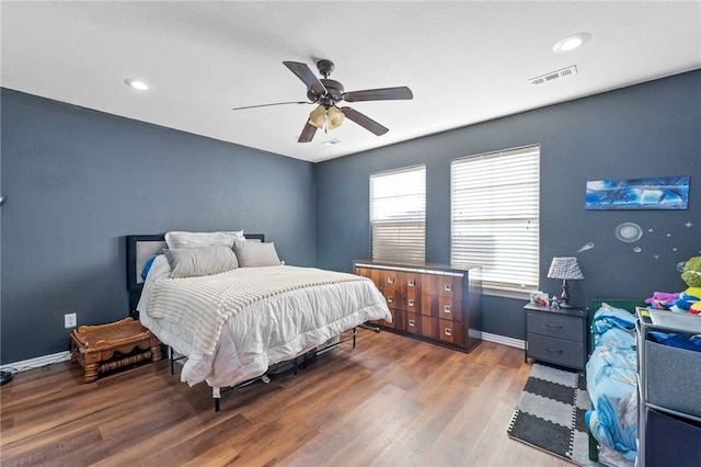 bedroom with recessed lighting, visible vents, ceiling fan, wood finished floors, and baseboards