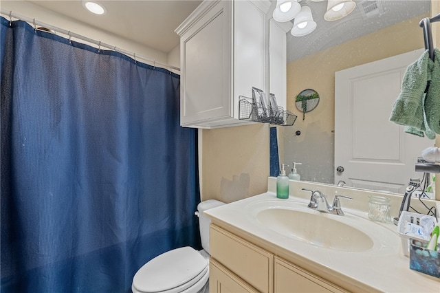 full bathroom with a shower with curtain, visible vents, vanity, and toilet