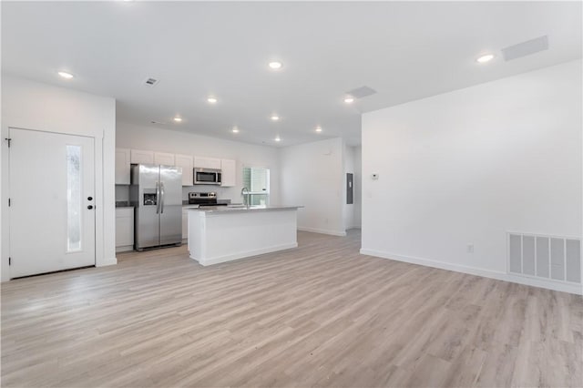 kitchen featuring open floor plan, appliances with stainless steel finishes, light wood finished floors, and visible vents