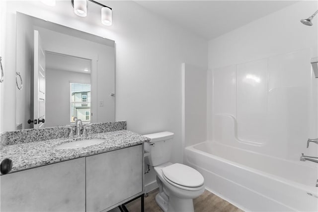 full bath featuring shower / tub combination, vanity, toilet, and wood finished floors