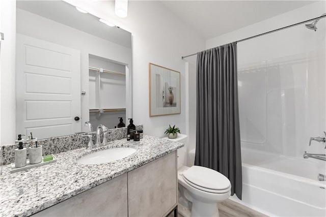 bathroom with shower / tub combo, vanity, and toilet