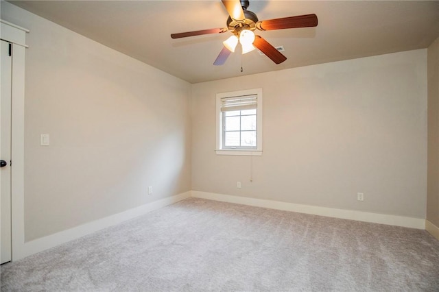 empty room featuring carpet floors, baseboards, and a ceiling fan