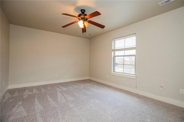 empty room with light carpet, baseboards, visible vents, and a ceiling fan