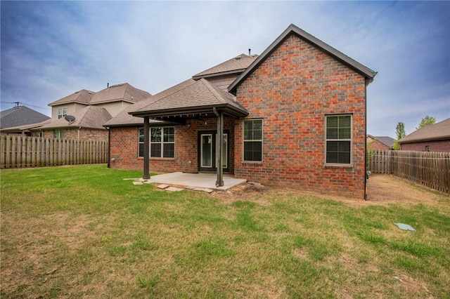 3601 SW Willowbrook Rd, Bentonville, AR 72713 - rear view of house featuring a lawn, a fenced backyard, a patio, and roof with shingles