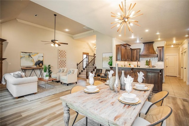 3601 SW Willowbrook Rd, Bentonville, AR 72713 - dining room with stairway, vaulted ceiling, crown molding, light wood finished floors, and visible vents