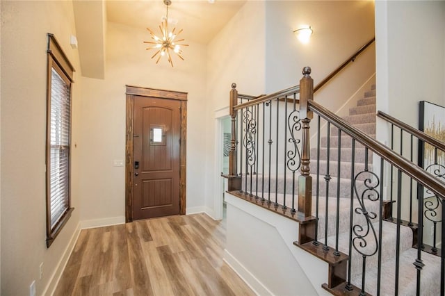 3601 SW Willowbrook Rd, Bentonville, AR 72713 - foyer entrance featuring a towering ceiling, plenty of natural light, wood finished floors, and an inviting chandelier