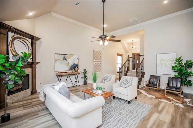 3601 SW Willowbrook Rd, Bentonville, AR 72713 - living room with stairway, visible vents, a ceiling fan, light wood-type flooring, and a glass covered fireplace