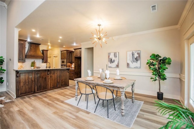3601 SW Willowbrook Rd, Bentonville, AR 72713 - dining area with light wood-style floors, visible vents, crown molding, and a notable chandelier