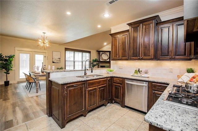3601 SW Willowbrook Rd, Bentonville, AR 72713 - kitchen with dark brown cabinetry, a peninsula, appliances with stainless steel finishes, and a sink