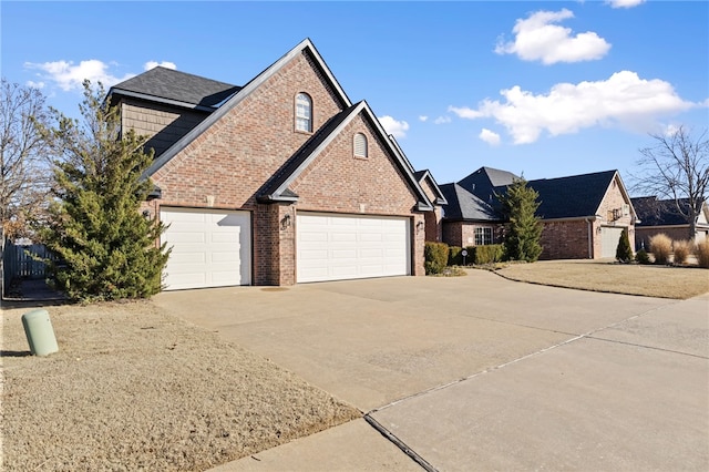 view of property exterior with brick siding and driveway