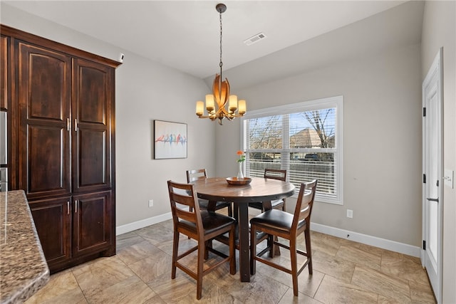 dining room featuring visible vents, a notable chandelier, and baseboards