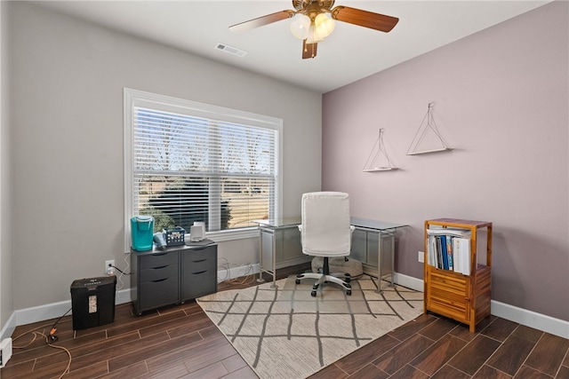 office area with wood finish floors, visible vents, ceiling fan, and baseboards