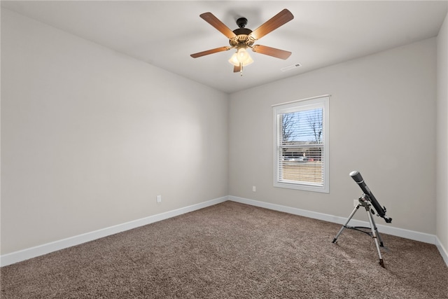 carpeted empty room featuring visible vents, ceiling fan, and baseboards