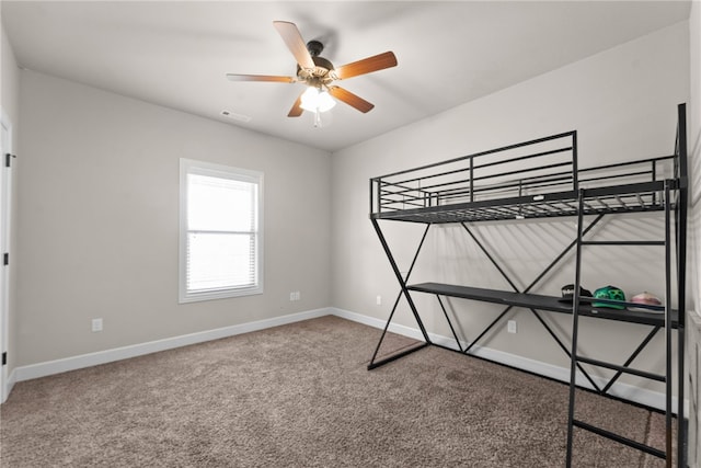 unfurnished bedroom with a ceiling fan, baseboards, visible vents, and carpet flooring