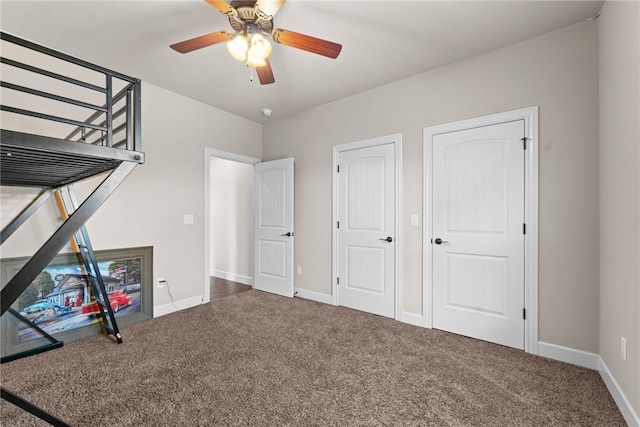 unfurnished bedroom featuring carpet flooring, a ceiling fan, and baseboards