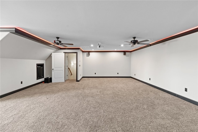 additional living space featuring ceiling fan, carpet, baseboards, and vaulted ceiling