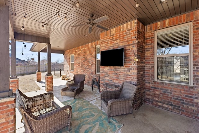 view of patio featuring fence and a ceiling fan