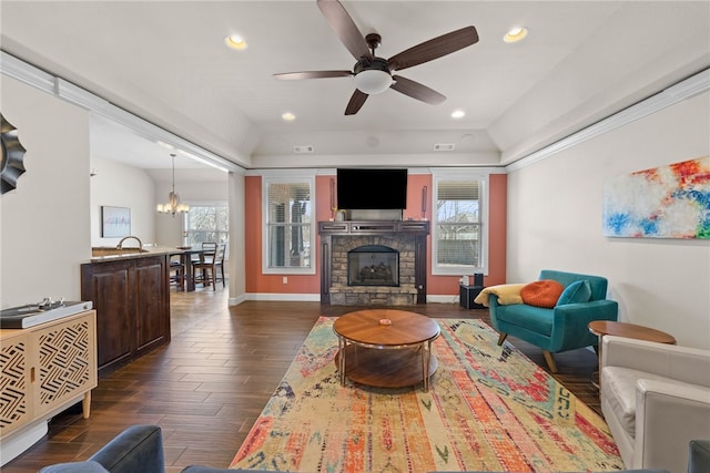 living room featuring a fireplace, dark wood-type flooring, a wealth of natural light, and recessed lighting