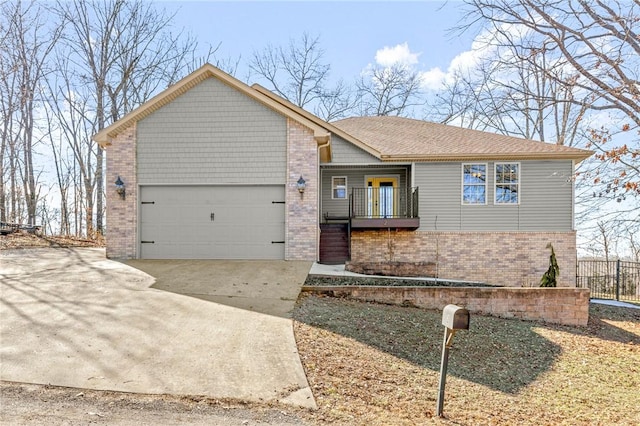 ranch-style house featuring concrete driveway, an attached garage, fence, and brick siding